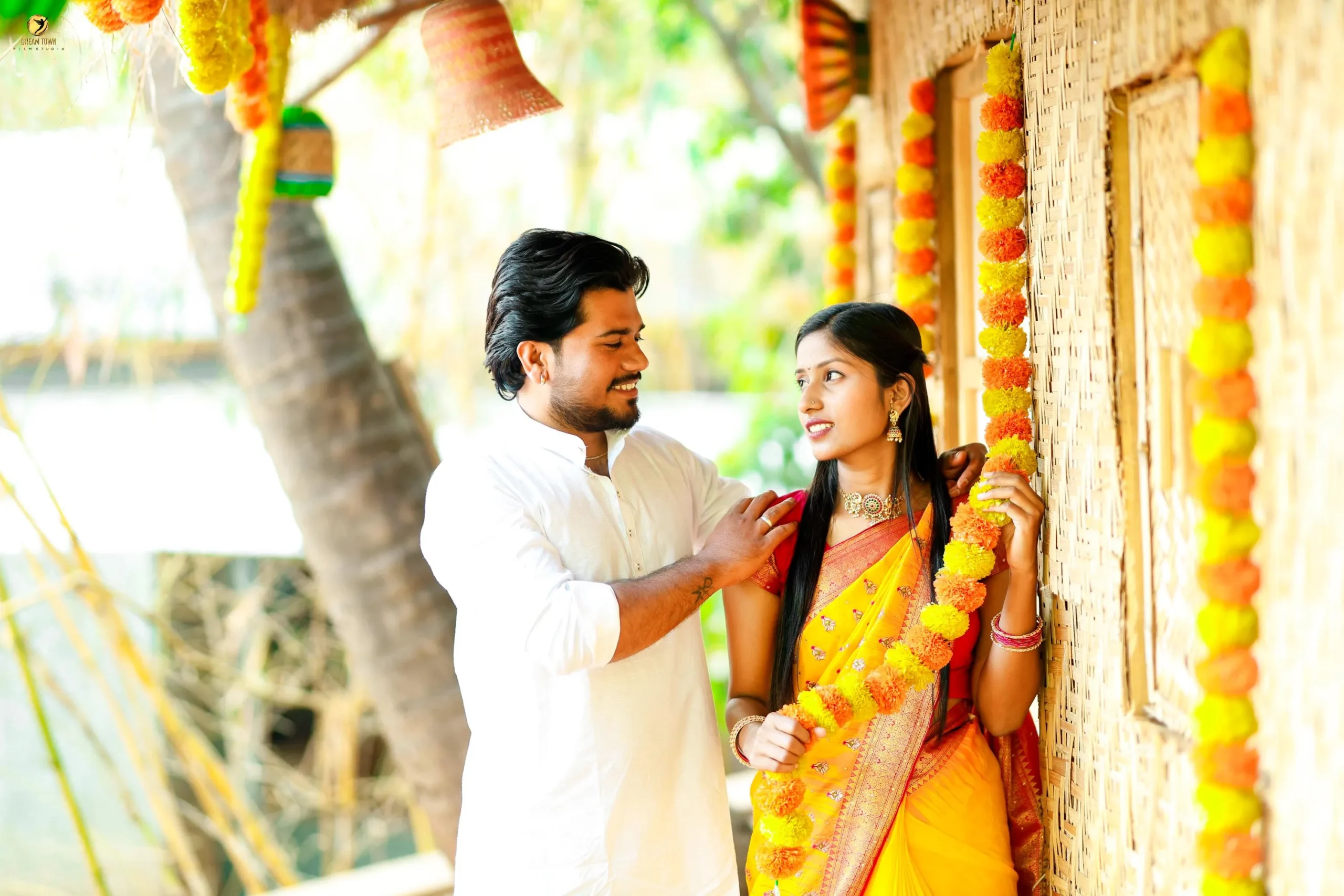 Bride in lehenga and groom in sherwani posing at Dream Town Film Studio