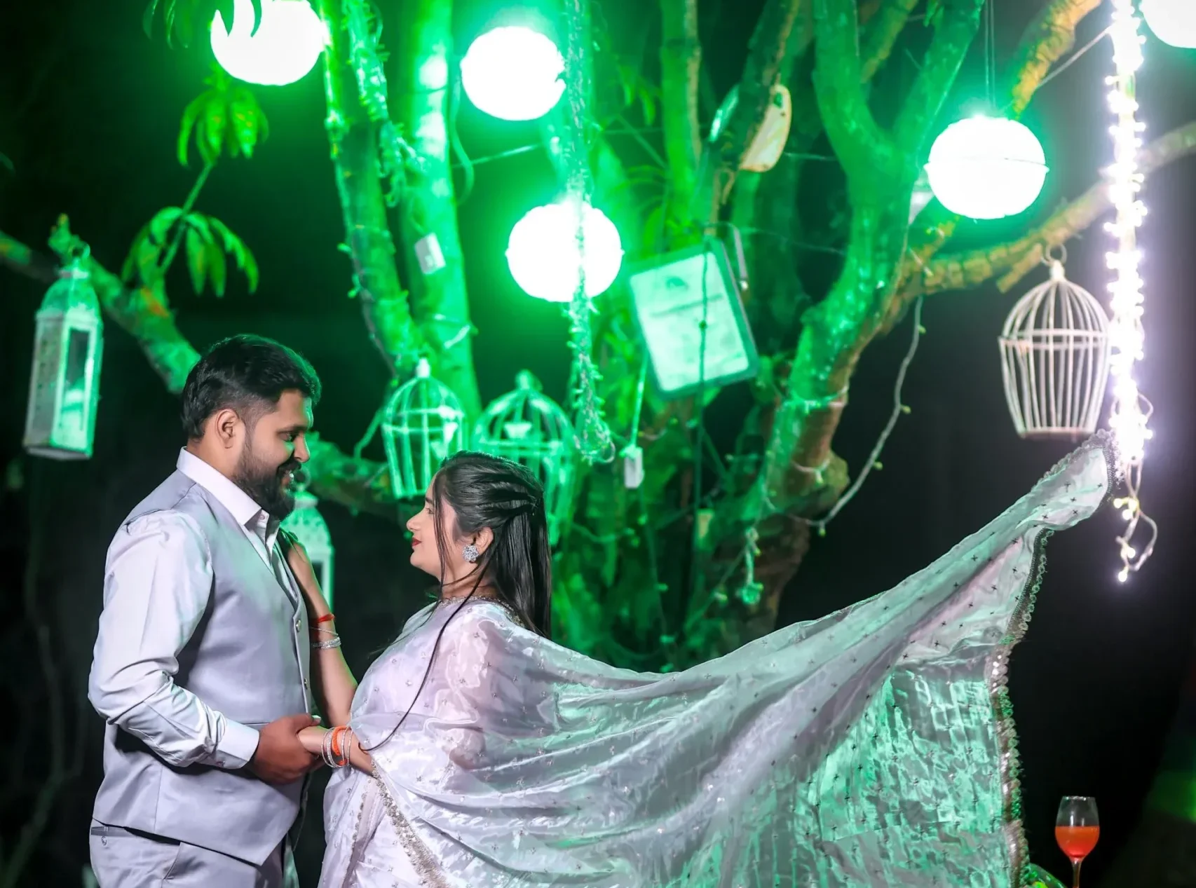 Bride in lehenga and groom in sherwani posing at Dream Town Film Studio