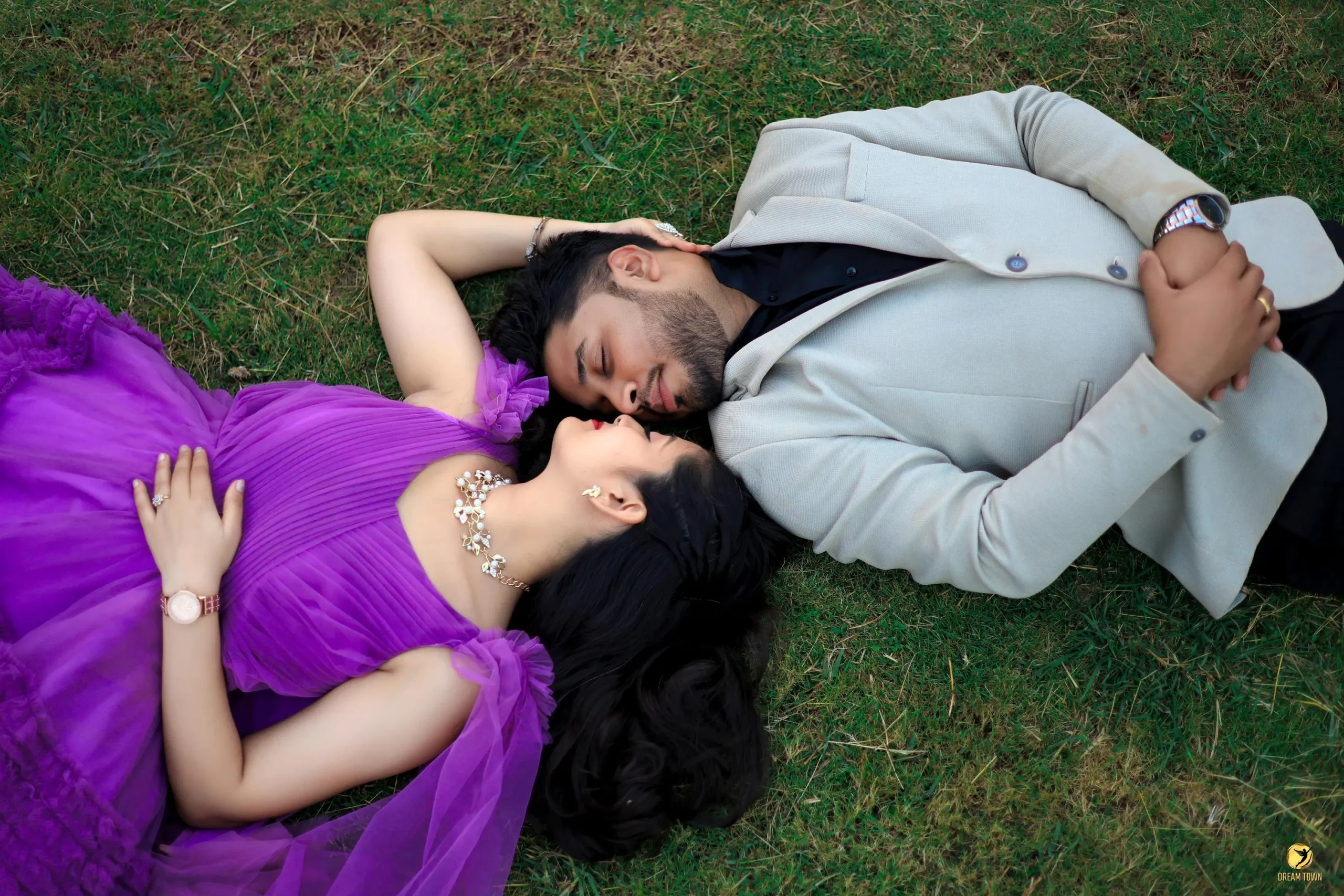 Bride in lehenga and groom in sherwani posing at Dream Town Film Studio